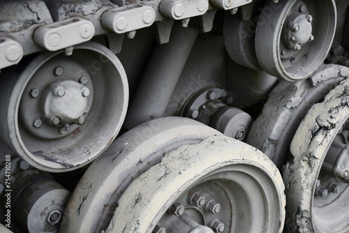 Closeup on tank tracks, idler gears.
