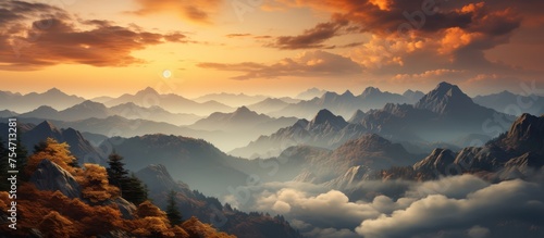 View of Mountain peaks in orange clouds at sunrise in summer