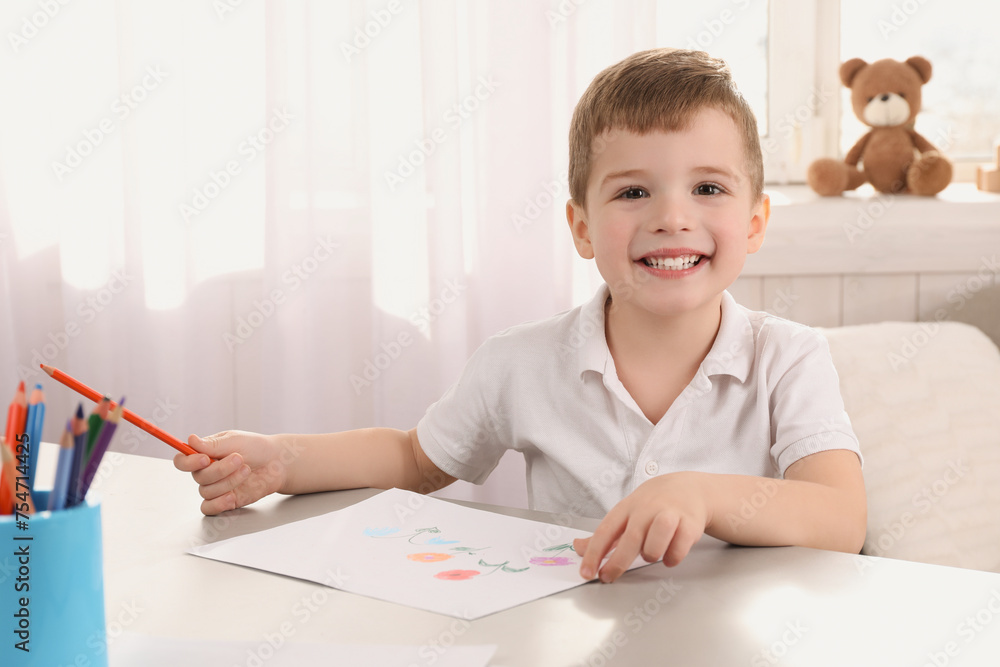 Cute little boy drawing with pencil at light table in room. Child`s art Cute little boy drawing with pencil at light table in room. Child`s art