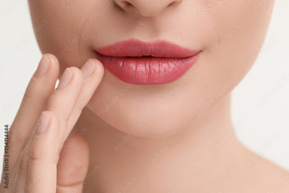 Young woman with beautiful full lips on white background, closeup Young woman with beautiful full lips on white background, closeup
