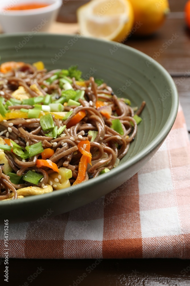 Stir-fry. Delicious cooked noodles with chicken and vegetables in bowl on table, closeup Stir-fry. Delicious cooked noodles with chicken and vegetables in bowl on table, closeup