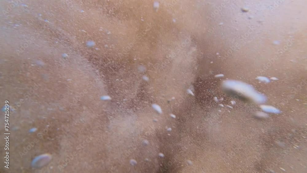 Slow motion view of sand explosion underwater. Slow motion view of sand explosion underwater.