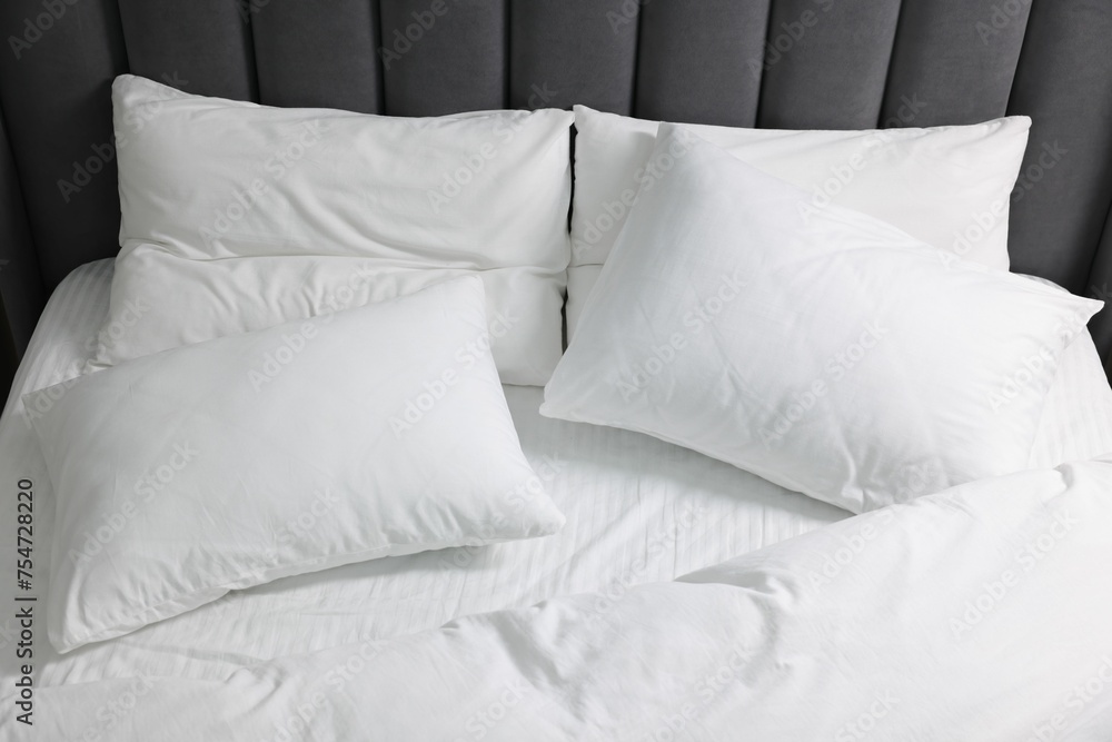 Soft white pillows and duvet on bed Soft white pillows and duvet on bed