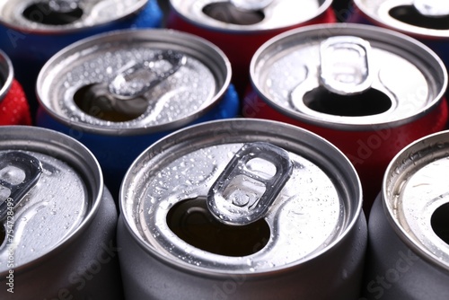 Energy drinks in wet cans as background, closeup. Functional beverage