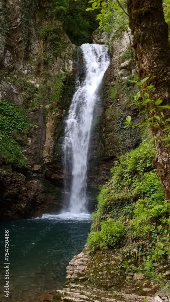 Waterfall with rocks among tropical jungle with water falling down Waterfall with rocks among tropical jungle with water falling down