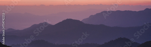 nature traveling with orange sky and layer of mountain with sunrise background