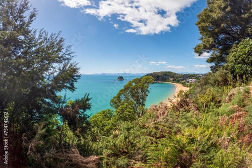 Iconic Beauty of Kaiteriteri Beach: A Panoramic View of its Golden Sands and Crystal-Clear Waters, a Beloved Summer Destination in New Zealand