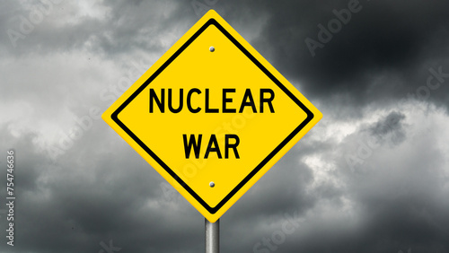 Yellow highway warning sign with dark storm clouds in the background and the words NUCLEAR WAR