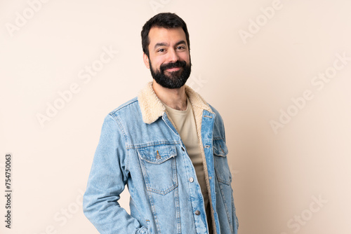 Caucasian man with beard over isolated background laughing