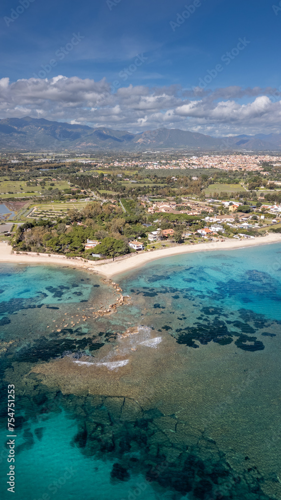 Panorama of the coast of Pula in Sardinia. Crystal clear sea and clouds in the distance