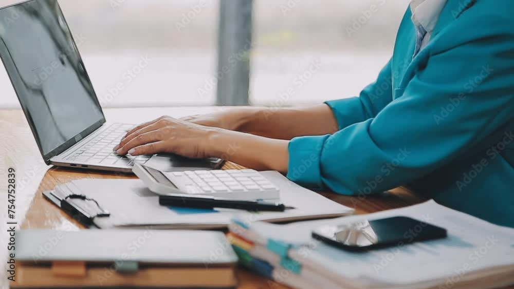 Businesswoman using phone, taking notes at office desk Businesswoman using phone, taking notes at office desk