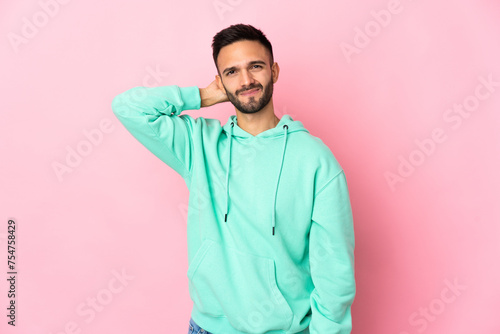 Young caucasian man isolated on pink background with an expression of frustration and not understanding