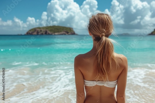 Back of girl on beach looking at sea