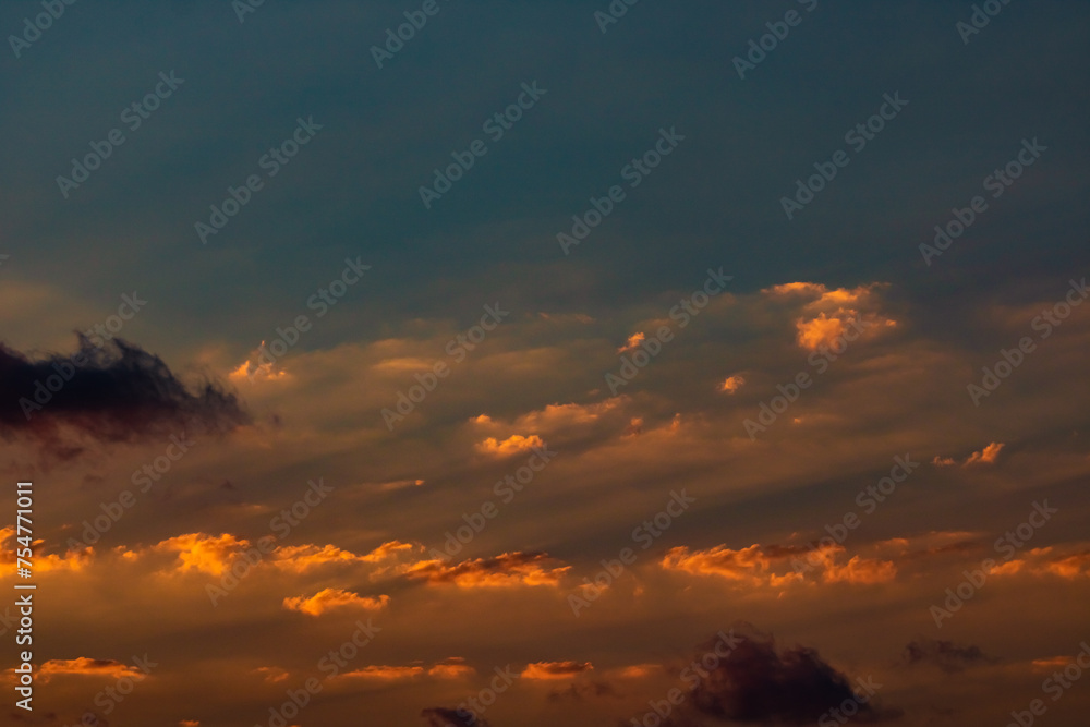 Partly cloudy sky at sunset with sunrays