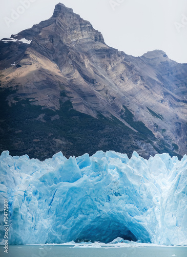 Majestic Ice Glacier Against Rugged Mountain Backdrop