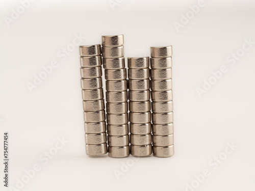 stacks of individual Neodynium silver strong magnets isolated on a white background hundreds of uses 6mm x 3 xx