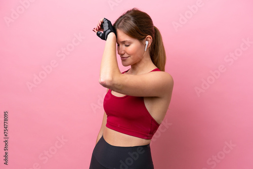 Young caucasian woman isolated on pink background with tired expression © luismolinero