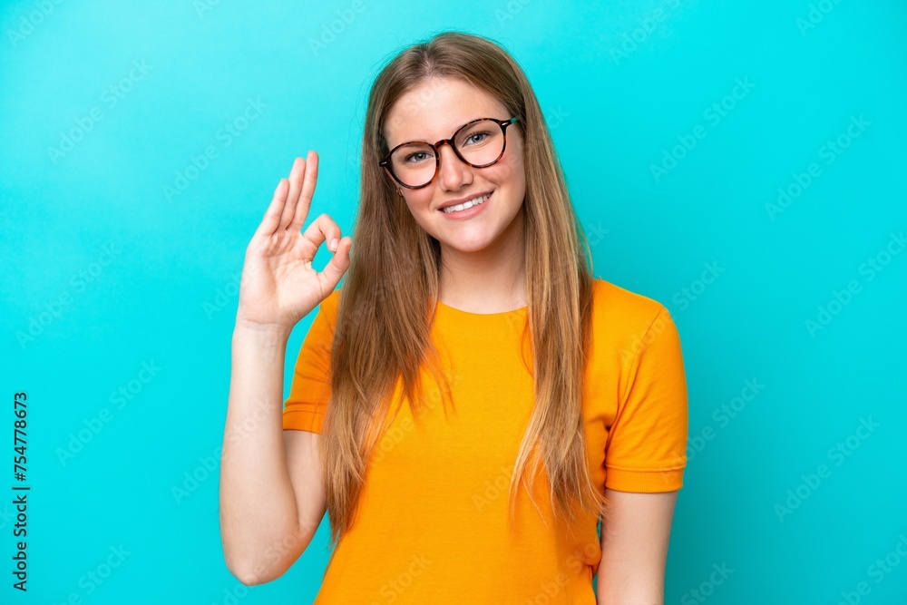 Young caucasian woman isolated on blue background showing ok sign with fingers Young caucasian woman isolated on blue background showing ok sign with fingers