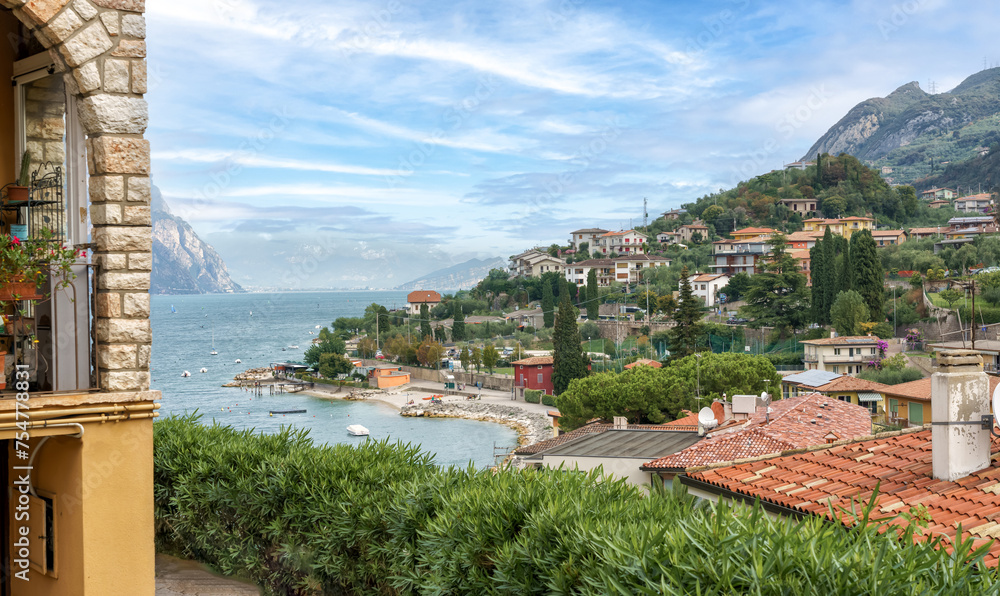 Scenic view of town of Malcesine and the beach at Garda lake, Veneto region, Italy. 