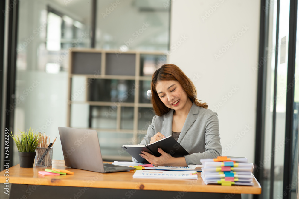 Asian business woman working and talking at the office Asian business woman working and talking at the office