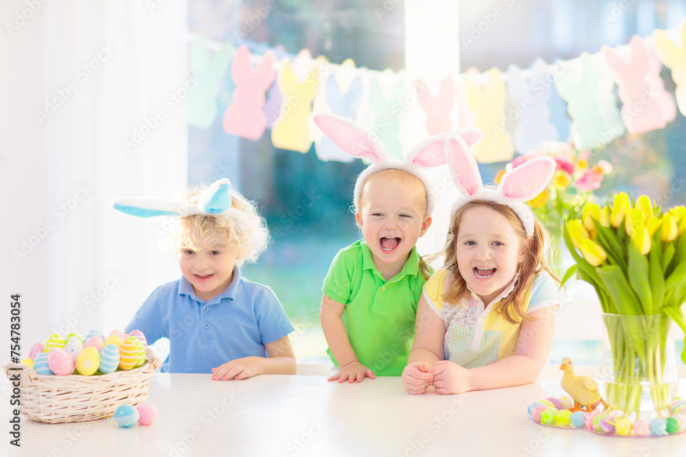 Fototapeta premium Kids on Easter egg hunt. Children dye eggs.