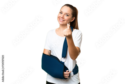 Young blonde woman with broken arm and wearing a sling over isolated chroma key background making money gesture