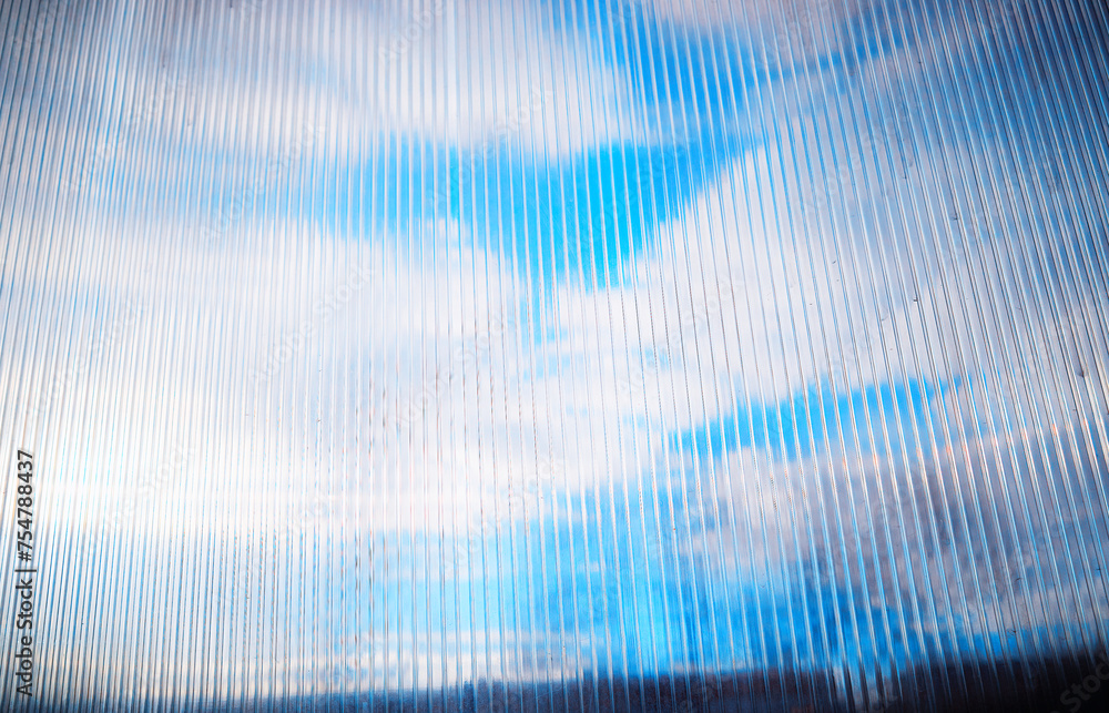 Fototapeta premium Daylight clouds through old plastic window limiter
