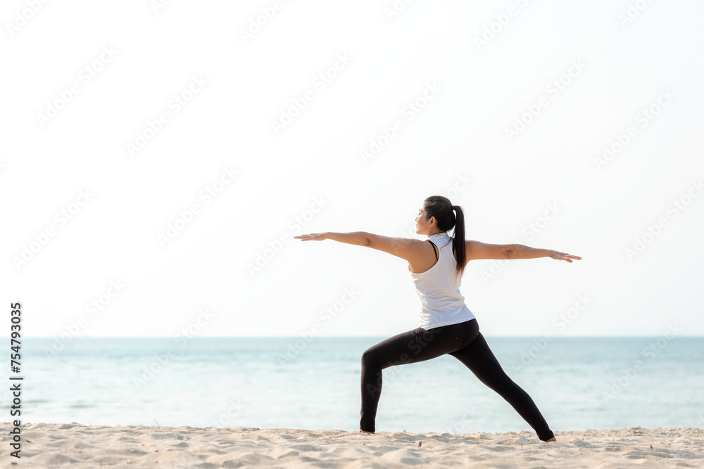 Lifestyle athletic woman yoga exercise and pose for healthy life.  Young girl or people pose balance body vital zen and meditation workout and fitness sport outdoor on sand beach.