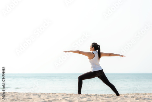 Lifestyle athletic woman yoga exercise and pose for healthy life.  Young girl or people pose balance body vital zen and meditation workout and fitness sport outdoor on sand beach.