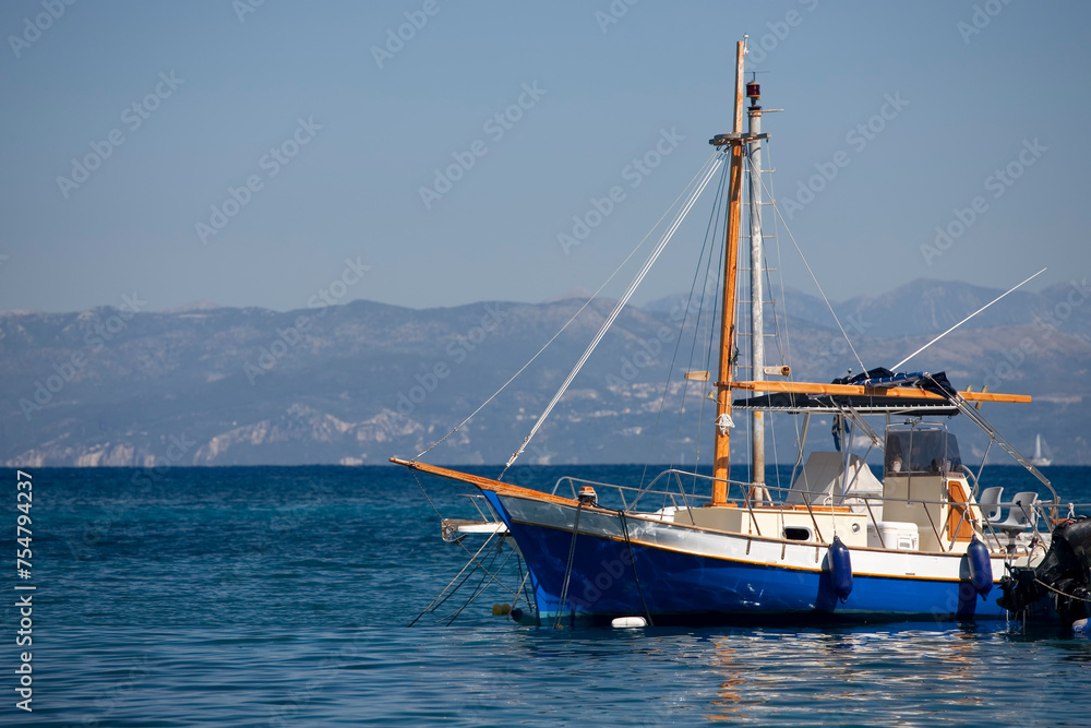 A fishing boat on the jetty in the village of Loggos, Paxos, Greece