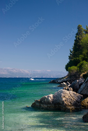 The coastline at the pretty little harbourside village of Loggos, Paxos, Greece photo