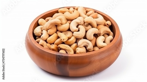 Cashew nuts are arranged in a wooden bowl and isolated on a white background, captured from a top-down view.