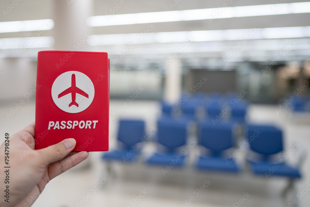 Hand holding passport at the airport at boarding gate. Hand holding passport at the airport at boarding gate.