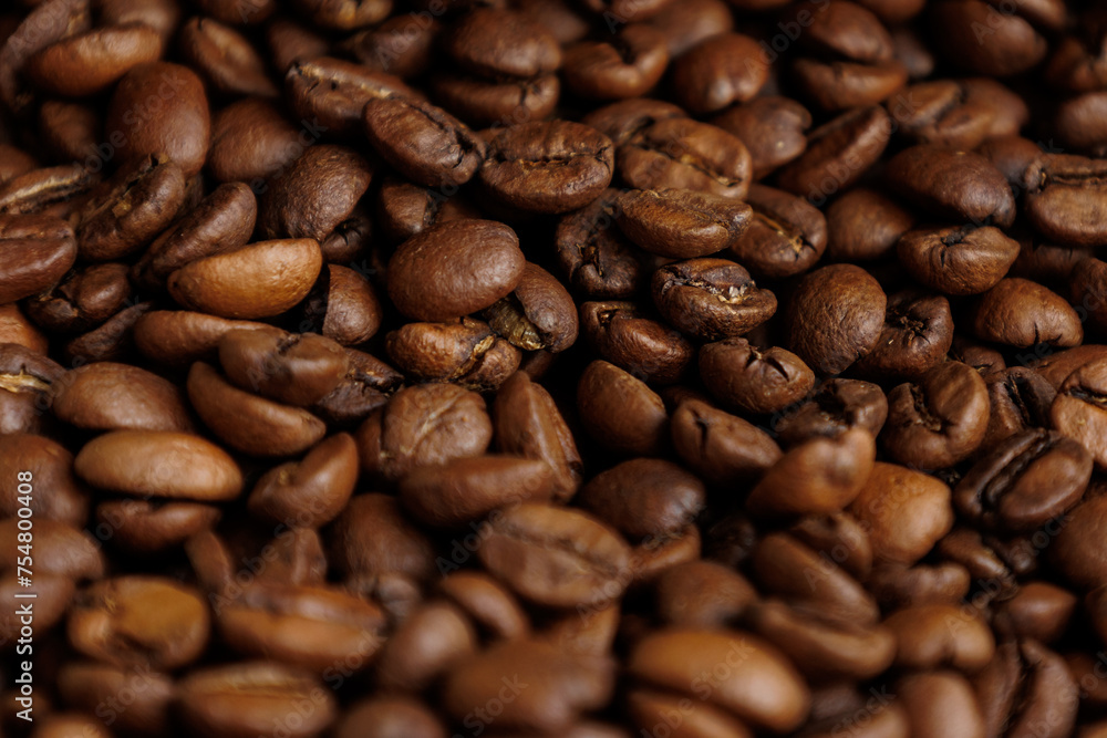 Fototapeta premium coffee beans are on table after roasting. Fresh converted coffee beans before packing in paper bag. Ground coffee for making Americano or cappuccino. grain cultivation and harvesting