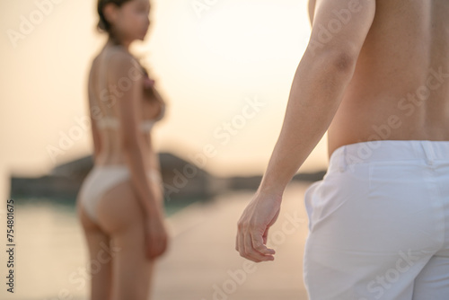 Young couple walking on the beach. photo