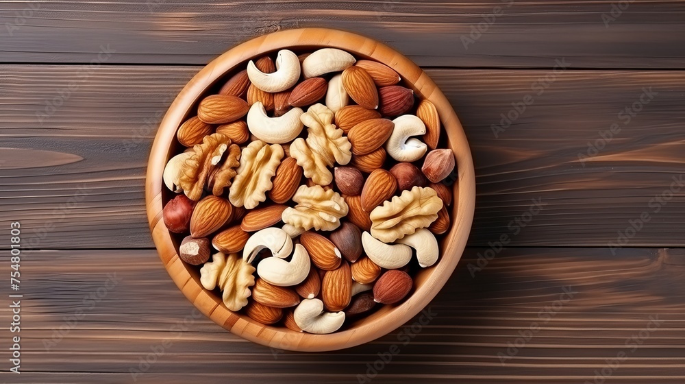 Mixed nuts are arranged in a wooden bowl, isolated against a white background, captured from a top-down perspective. Mixed nuts are arranged in a wooden bowl, isolated against a white background, captured from a top-down perspective.
