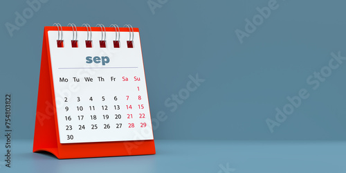 2024 September spiral monthly desk calendar. 3D rendered horizontal page on blue background with copy space. Set of 12 month layouts. Week starts with Monday. Weekends marked in red. photo
