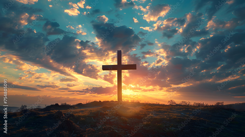 A wooden cross on a hill at sunset. The sky is a mix of blue, red, and purple clouds. A wooden cross on a hill at sunset. The sky is a mix of blue, red, and purple clouds.