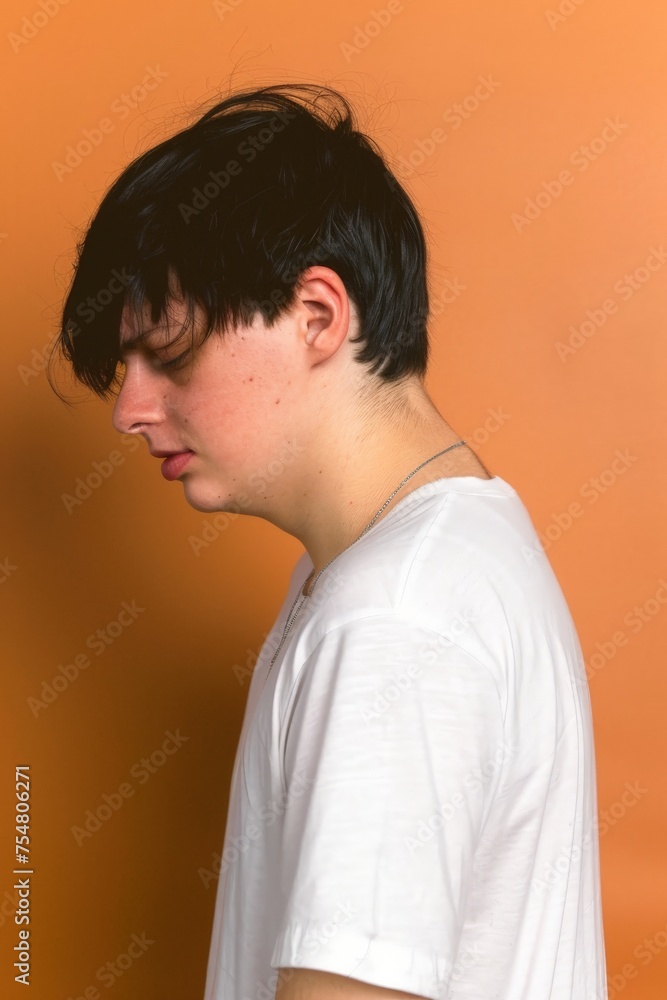 Young Man Standing in Front of Orange Wall. Generative AI Young Man Standing in Front of Orange Wall. Generative AI