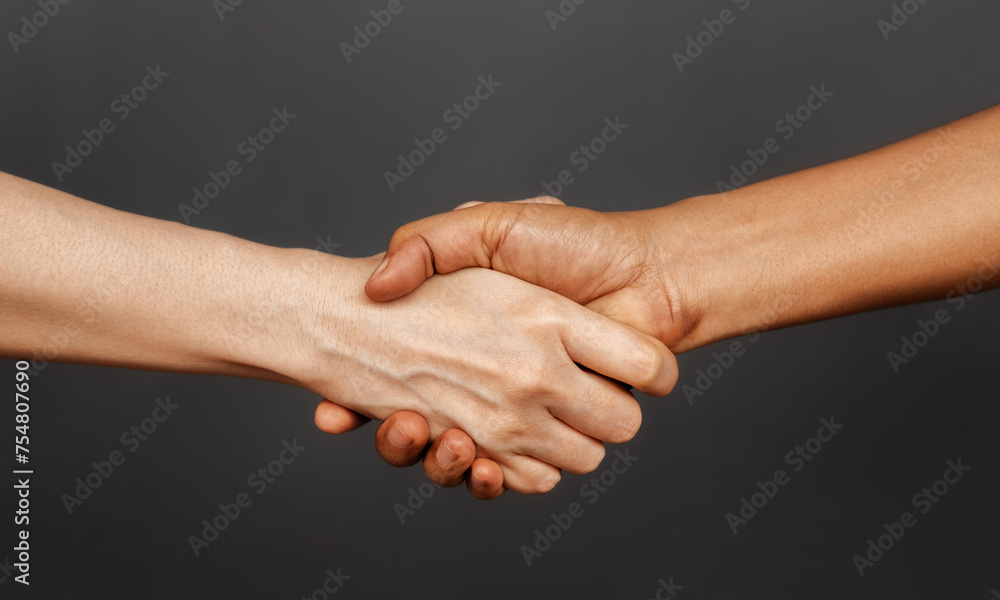 Close Up of Two People Shaking Hand together. Sign of Human Cooperation ,Agreement, Congratulations, Mergers and Acquisitions. Greeting or Finishing up Meeting. Handshaking with Great Deal. Close Up of Two People Shaking Hand together. Sign of Human Cooperation ,Agreement, Congratulations, Mergers and Acquisitions. Greeting or Finishing up Meeting. Handshaking with Great Deal.