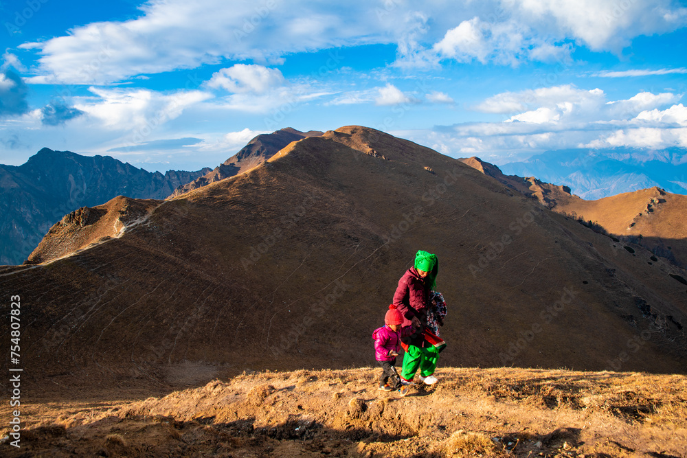 ocal Woman with a child Navigating the High Altitude Trails from Rara Lake to Jumla, Nepal