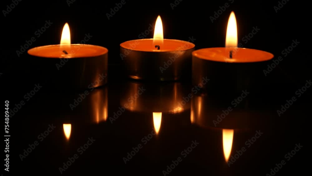 Three candles burning, isolated on black background. Concept of religion, death, memoriam and peace Three candles burning, isolated on black background. Concept of religion, death, memoriam and peace
