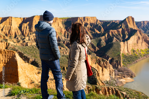 estranged angry couple think about their divorce in breathtaking scenery of mountains and red cliffs photo