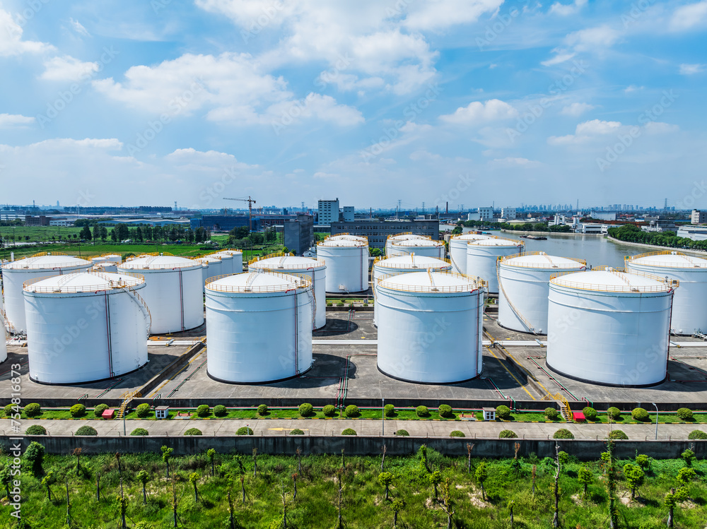 Aerial view of large white Industrial oil tanks. Business fuel and energy. Aerial view of large white Industrial oil tanks. Business fuel and energy.