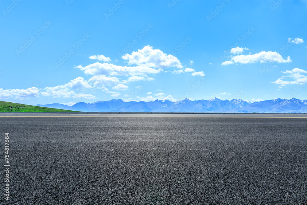 Fototapeta premium Asphalt road and mountain nature landscape under blue sky