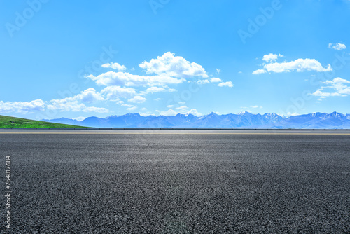 Asphalt road and mountain nature landscape under blue sky © ABCDstock