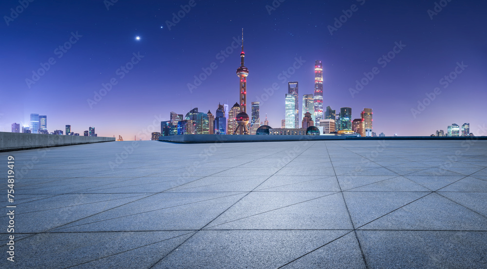 Empty square floor and modern city buildings sceney at night in Shanghai