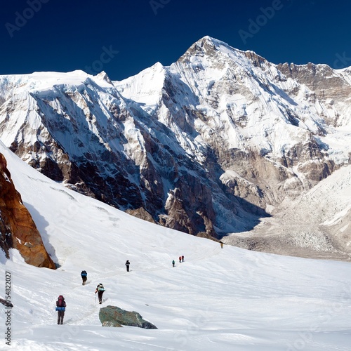 Mount Cho Oyu and group of hikers on glacier