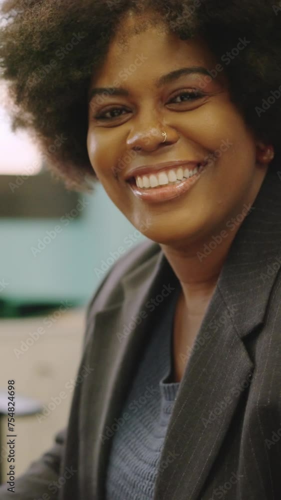 African american coworker smiling at camera sitting in the office African american coworker smiling at camera sitting in the office