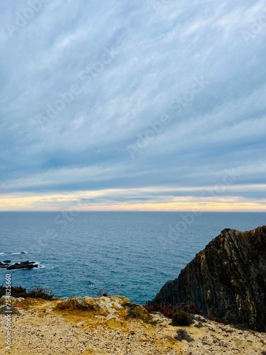 Fantastic rocky coast, cloudy sky, twilights time, ocean horizon